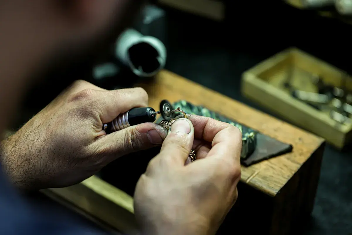 Jeweller setting a ring at a workbench
